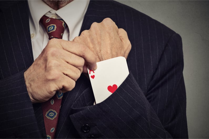 Closeup cropped image of man hand pulling out a hidden ace from his sleeve