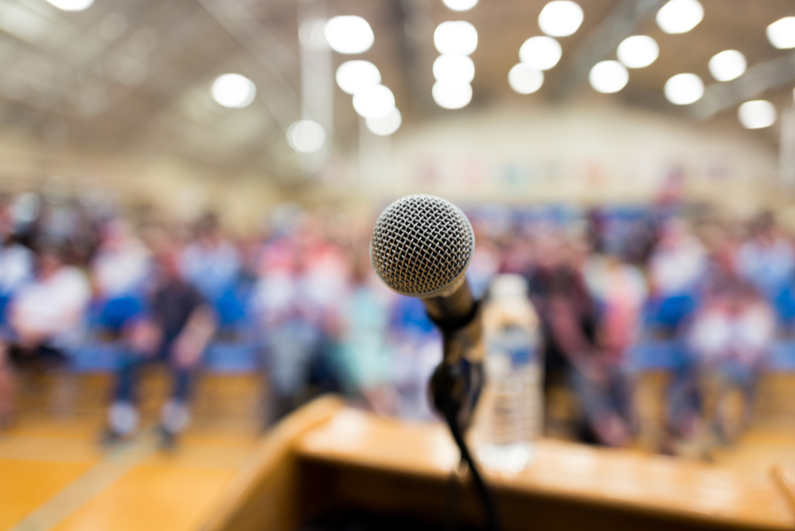 Closeup of a microphone in an auditorium