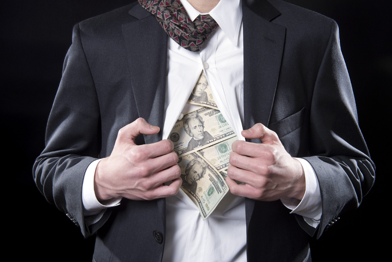 Businessman pulling back his shirt to reveal hidden money.