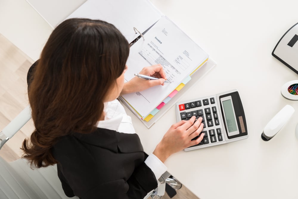 woman working out accounts using a calculator