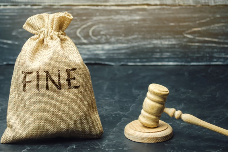 Gavel next to a bag labeled "FINE"