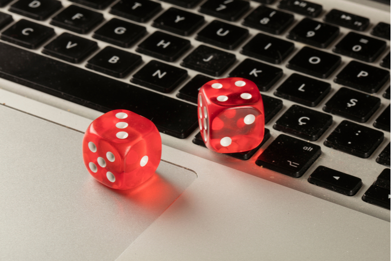 Red dice on laptop keyboard